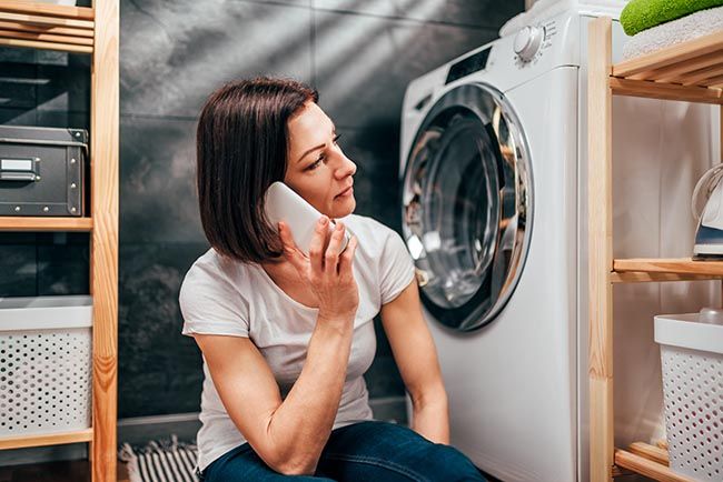 woman applying for a small loan to fix a broken washing machine